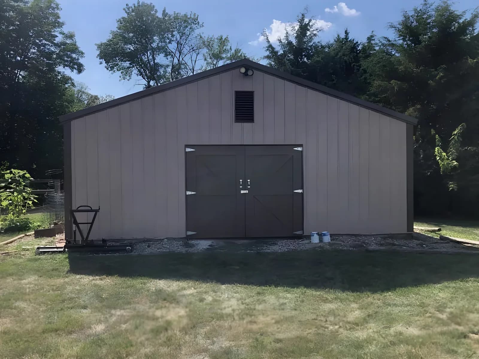 Pole barn repainted tan with dark doors