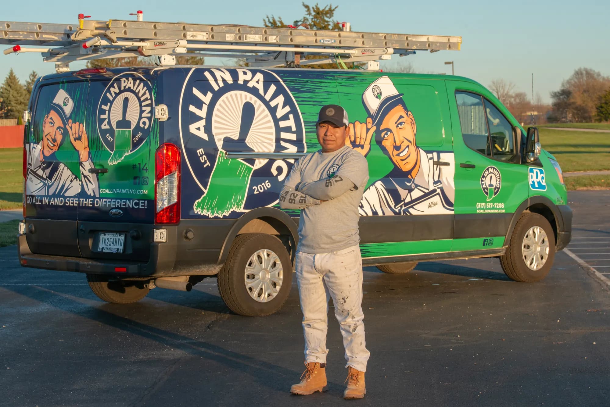 ALL IN Painting crew member standing in front of a branded work van