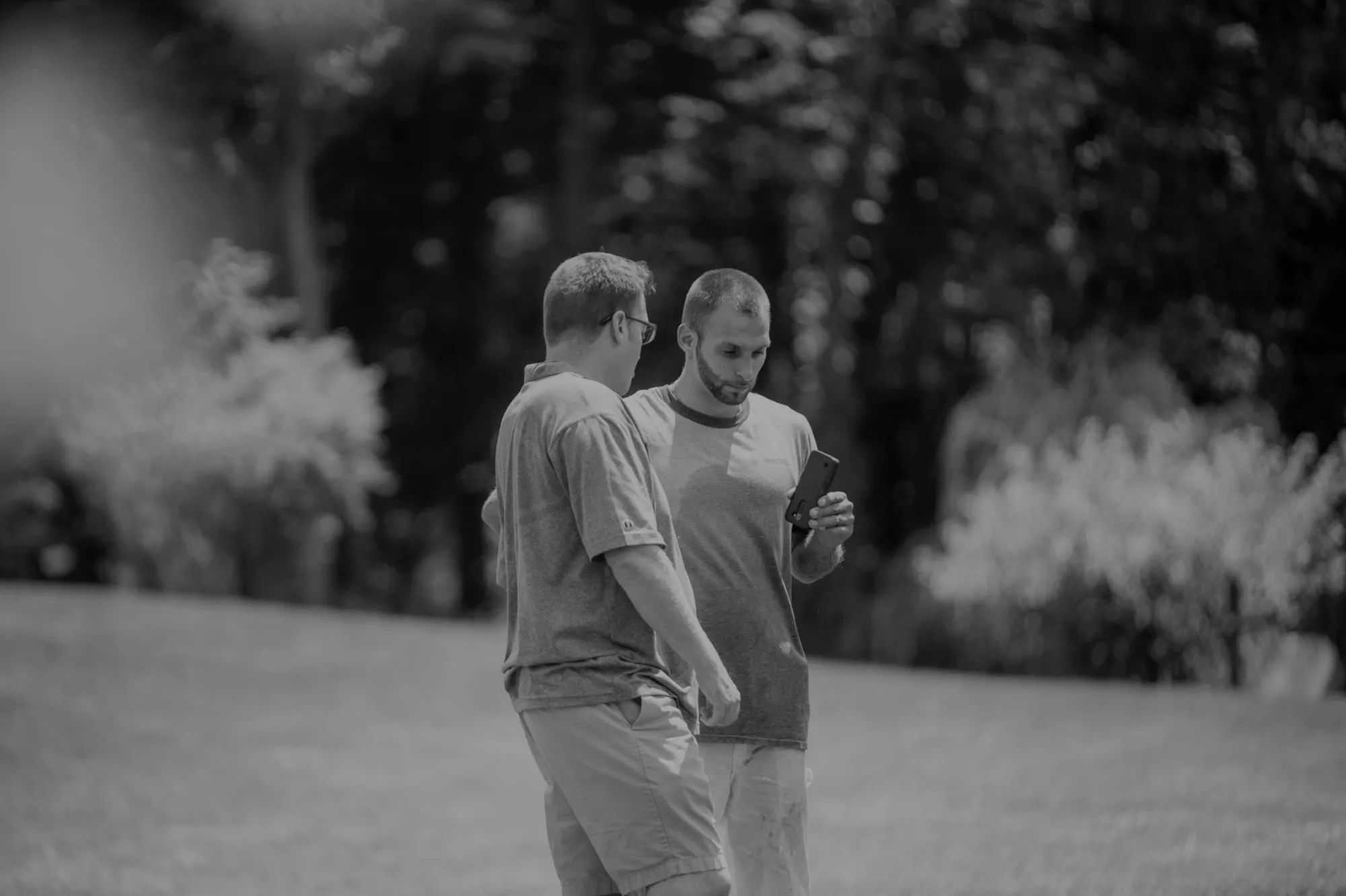 An ALL IN estimator walking a yard with a homeowner